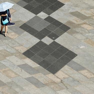 A woman shields herself from the sun with an umbrella on a hot summer day in Cologne, Germany, July 25, 2019.