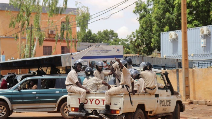 Police officers on the sidelines of a march in support of the coup plotters in Niger’s capital, Niamey, July 30, 2023. © 2023 Djibo Issifou/picture-alliance/dpa/AP Images