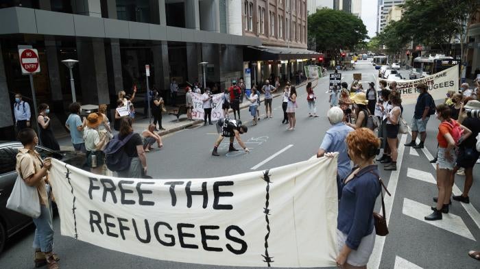 Activists gather in Brisbane's ANZAC Square to protest the indefinite detention of refugees and asylum seekers in Australian-run and funded facilities on the mainland and on Papua New Guinea's Manus Island, January 19, 2022.